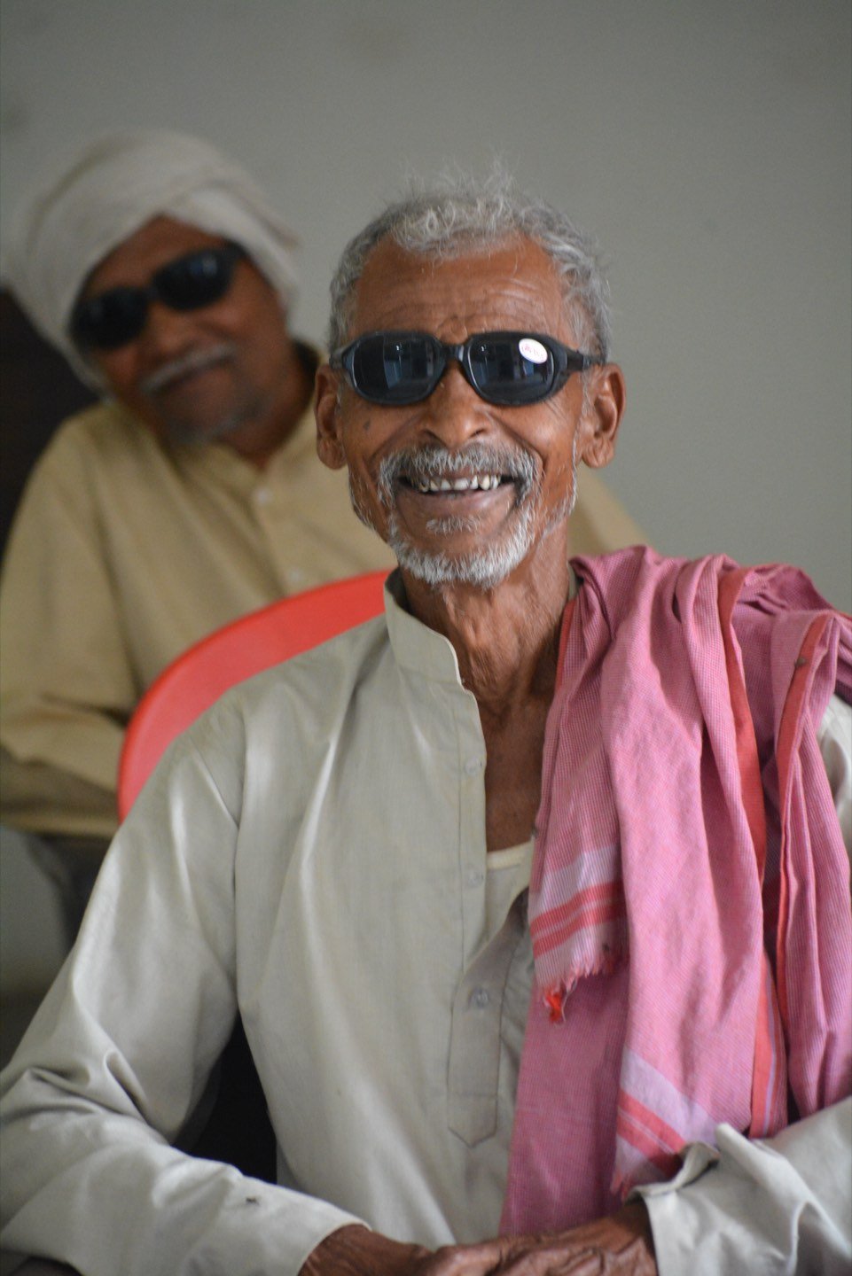 An elderly man smiling after free cataract surgery at Indumati Netralaya